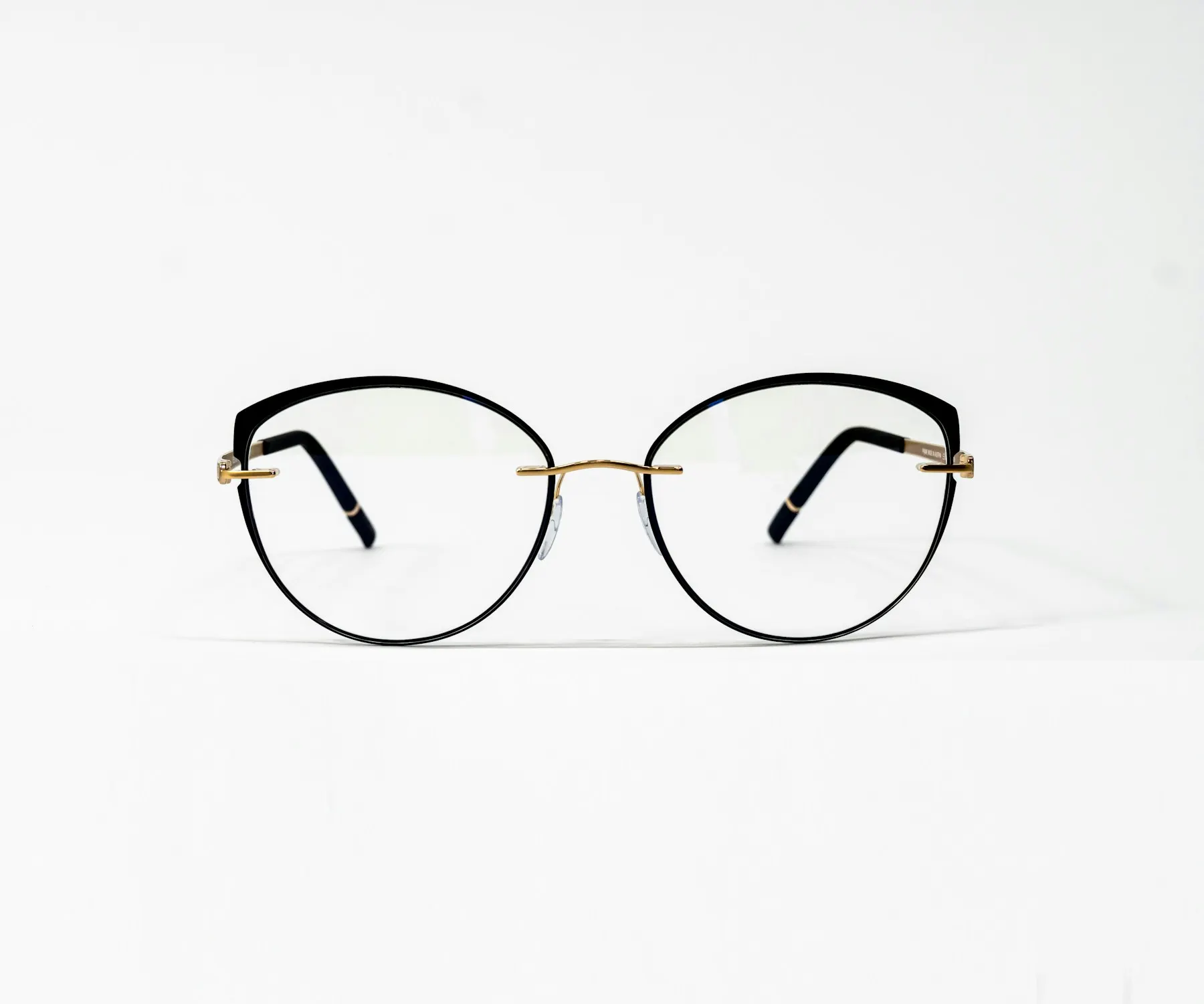 A pair of prescription frames on a white surface